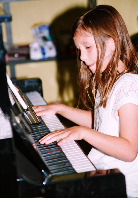 child playing a piano