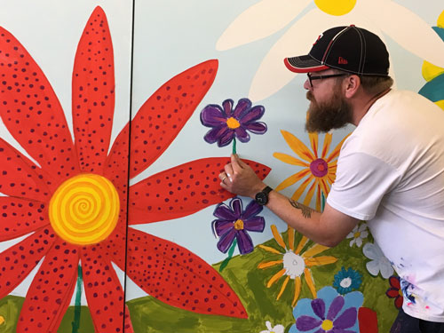 Nate with DAC mural