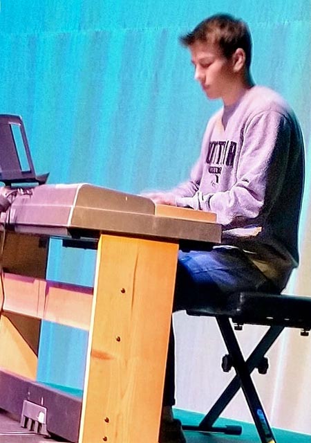 boy playing on keyboard